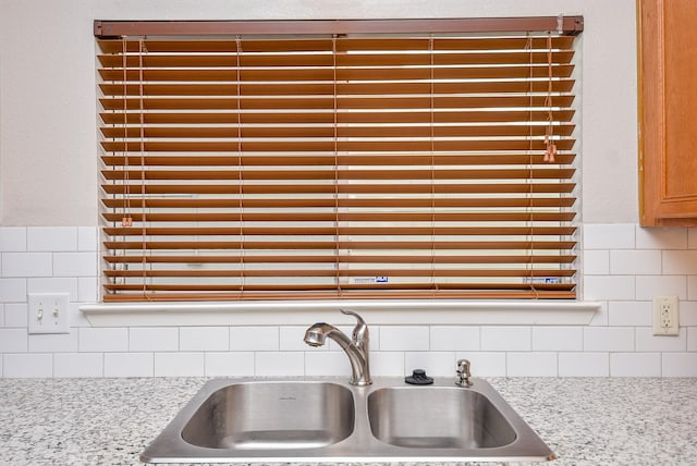 details featuring backsplash and a sink