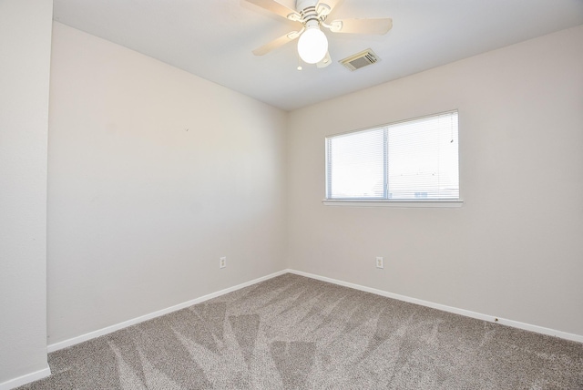 empty room featuring a ceiling fan, carpet flooring, baseboards, and visible vents