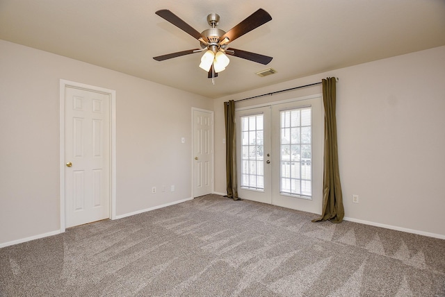 unfurnished room with visible vents, a ceiling fan, french doors, carpet floors, and baseboards