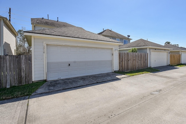 detached garage featuring fence