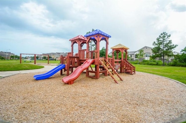 community jungle gym with a lawn