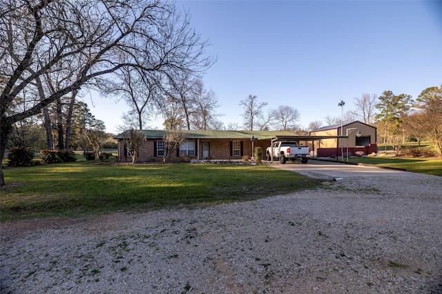 ranch-style house with a front yard, a carport, and driveway