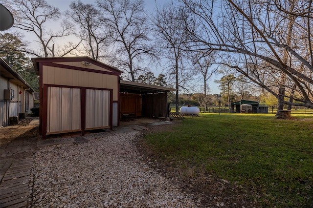 view of yard featuring an outbuilding, a carport, and a pole building