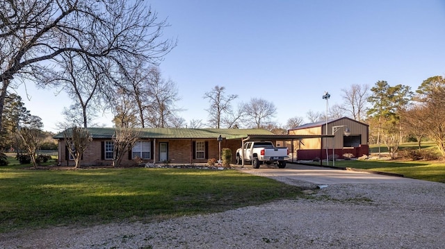 ranch-style home featuring a carport, gravel driveway, and a front lawn