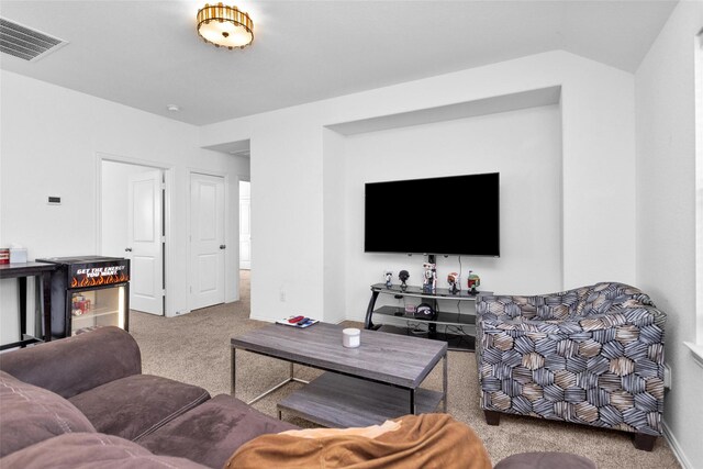 living room featuring lofted ceiling, baseboards, visible vents, and carpet floors