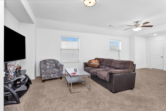 carpeted living area with baseboards, visible vents, and ceiling fan