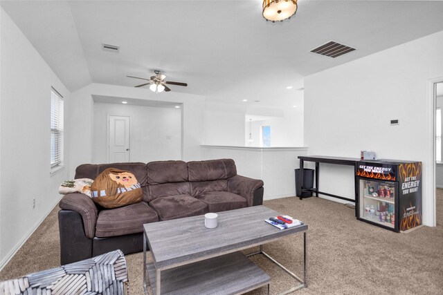 carpeted living area featuring visible vents, baseboards, ceiling fan, and vaulted ceiling