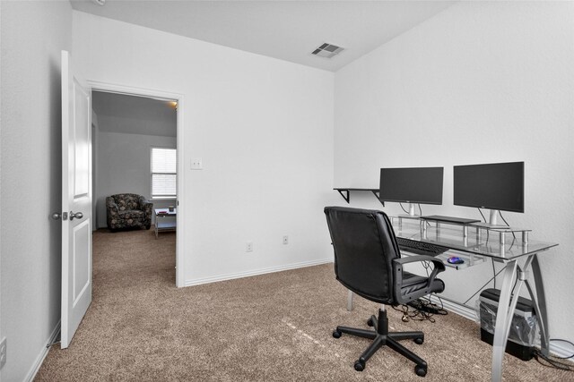 carpeted office space with visible vents and baseboards