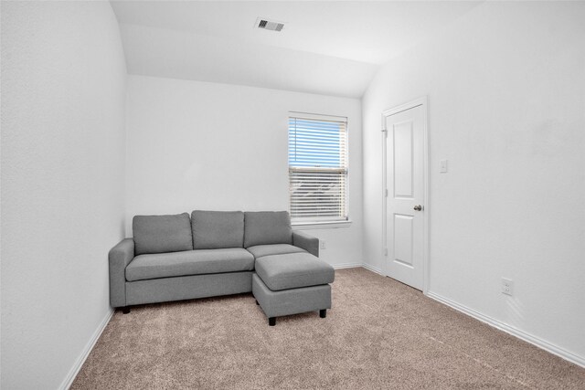 sitting room featuring vaulted ceiling, carpet, visible vents, and baseboards