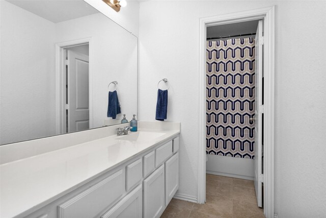 bathroom featuring vanity, tile patterned floors, and baseboards