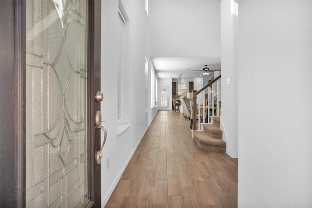 118 Emory Birch Dr, Montgomery, TX 77316 - foyer featuring ceiling fan, wood finished floors, baseboards, and stairway