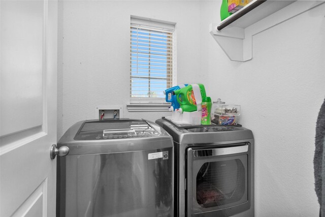 washroom featuring laundry area and washer and dryer