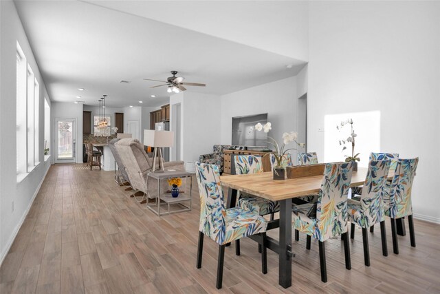 dining room with recessed lighting, light wood-style flooring, baseboards, and ceiling fan