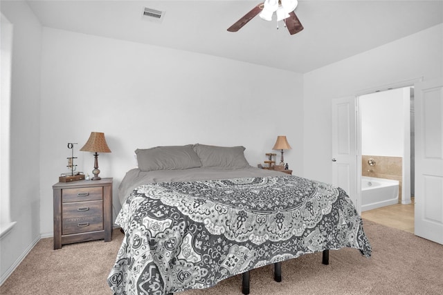 118 Emory Birch Dr, Montgomery, TX 77316 - carpeted bedroom featuring ensuite bath, visible vents, and a ceiling fan
