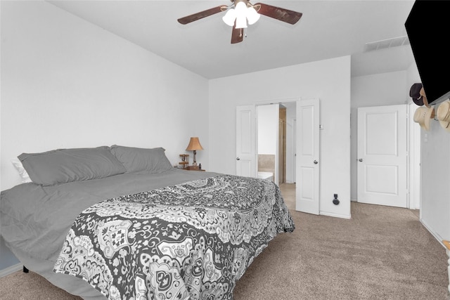 118 Emory Birch Dr, Montgomery, TX 77316 - carpeted bedroom with visible vents, baseboards, ceiling fan, and ensuite bathroom