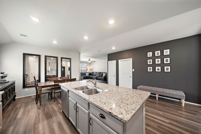 kitchen with dark wood-type flooring, gray cabinets, a sink, open floor plan, and dishwasher