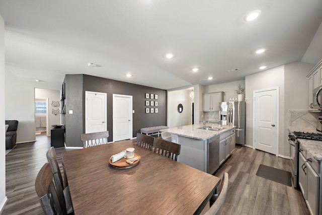 dining room featuring visible vents, dark wood-type flooring, baseboards, vaulted ceiling, and recessed lighting