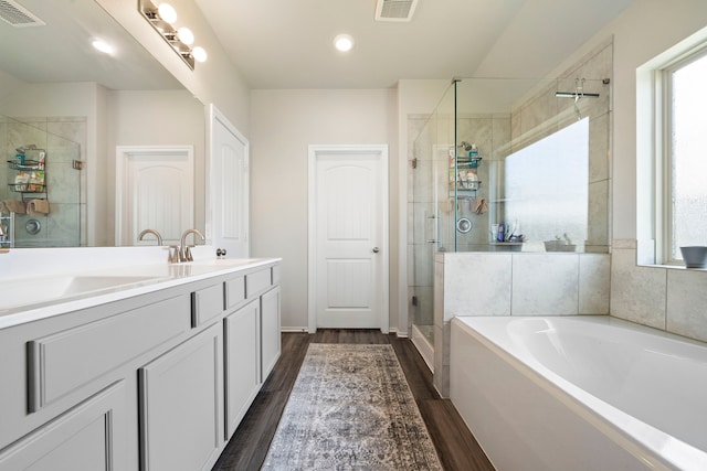 full bathroom featuring visible vents, a garden tub, and a shower stall