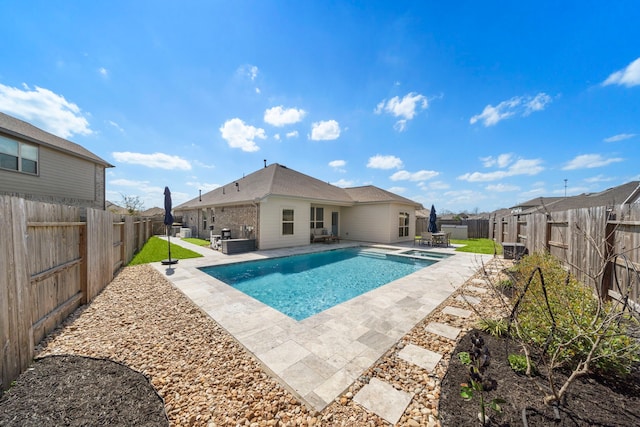 view of pool with a patio, a fenced backyard, and a pool with connected hot tub