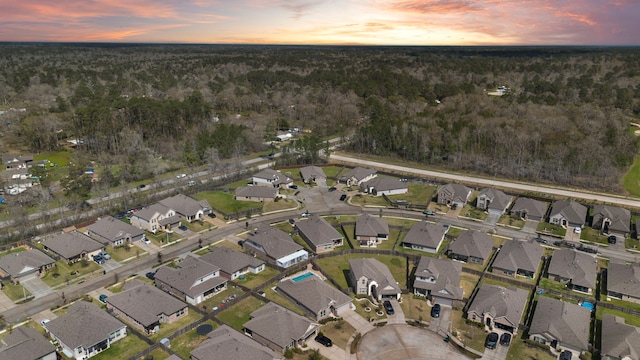 aerial view at dusk featuring a residential view