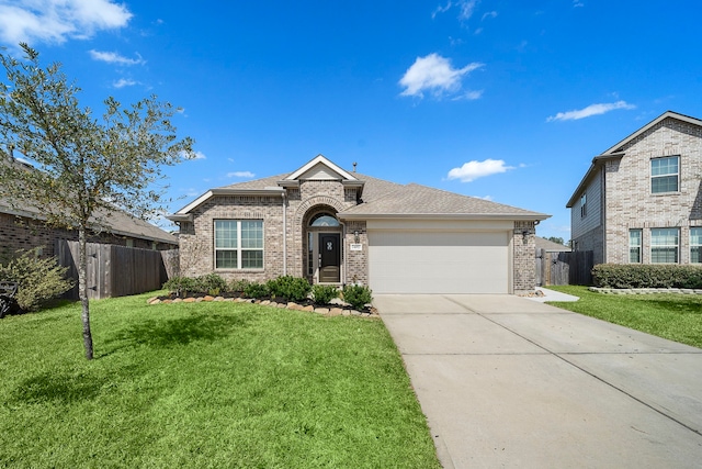 view of front of home featuring a front yard, brick siding, driveway, and fence