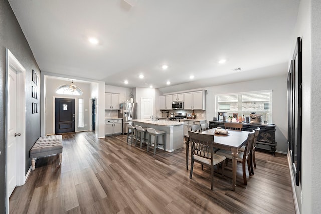 dining area featuring dark wood finished floors, visible vents, recessed lighting, and baseboards