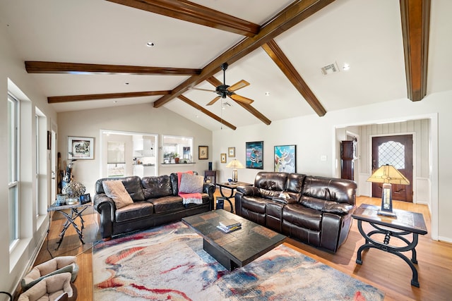 living area with lofted ceiling with beams, visible vents, wood finished floors, and ceiling fan