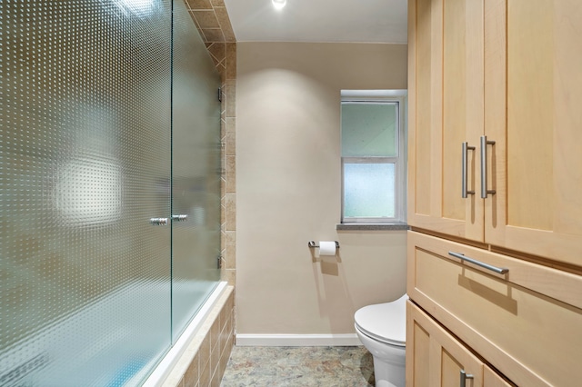 bathroom with baseboards and toilet