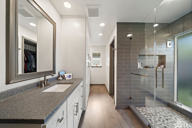 bathroom featuring vanity, baseboards, visible vents, recessed lighting, and a stall shower