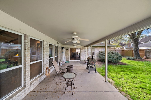 view of patio / terrace with grilling area, a ceiling fan, and fence