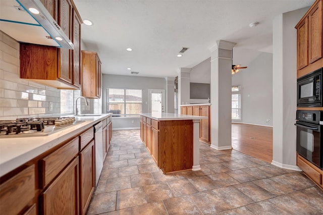 kitchen featuring tasteful backsplash, a center island, ventilation hood, black appliances, and a ceiling fan