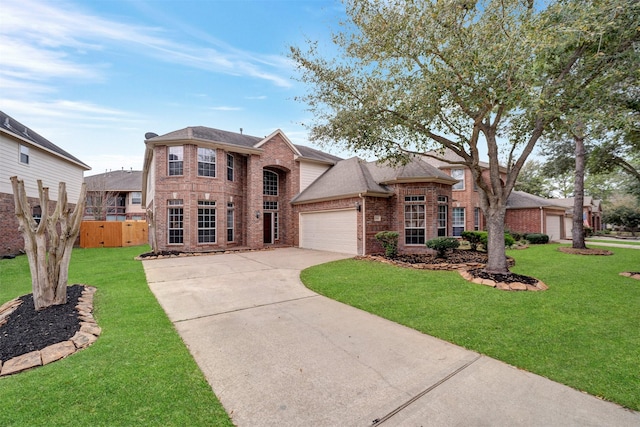 traditional-style home featuring a front lawn, a garage, brick siding, and driveway