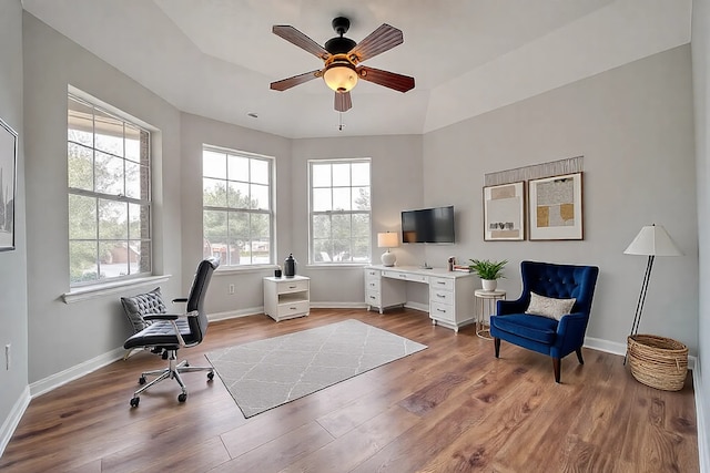 office area with a ceiling fan, wood finished floors, and baseboards