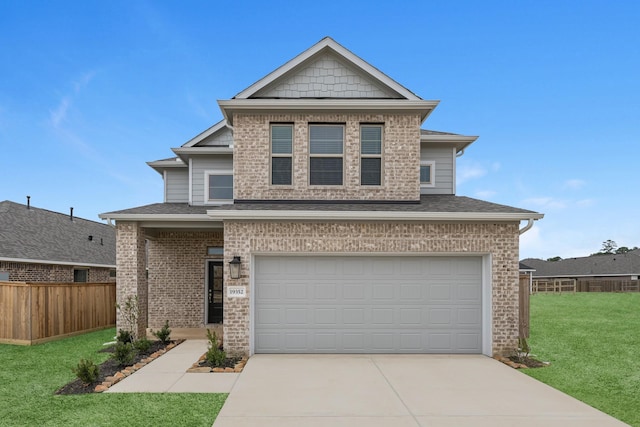 view of front of house with fence, driveway, a shingled roof, a front lawn, and a garage