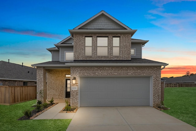 traditional-style house featuring concrete driveway, a yard, fence, and a garage