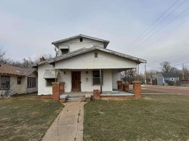 view of front of home with a porch and a front yard