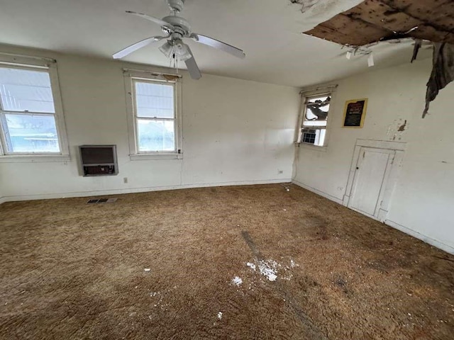 unfurnished room featuring visible vents, baseboards, and ceiling fan