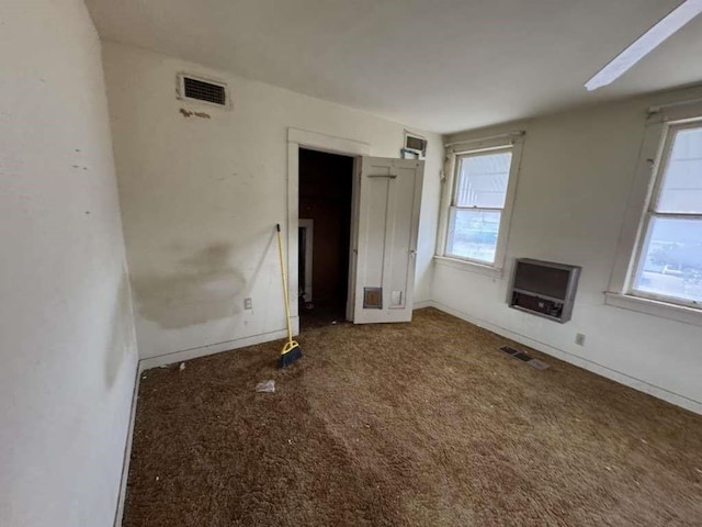 interior space with heating unit, visible vents, and a wealth of natural light