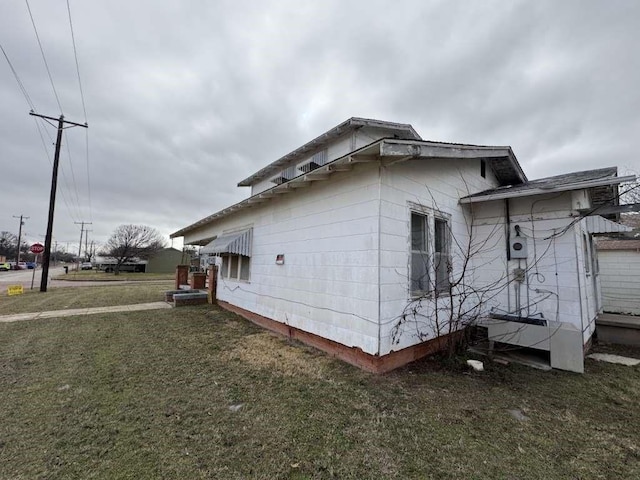 view of side of home featuring a lawn