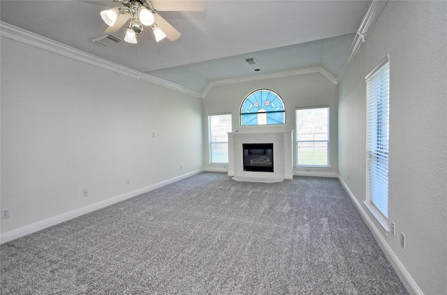 unfurnished living room featuring visible vents, a tiled fireplace, lofted ceiling, ornamental molding, and carpet flooring