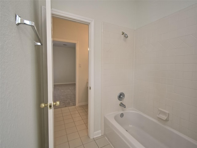 bathroom featuring tile patterned floors, shower / tub combination, and baseboards