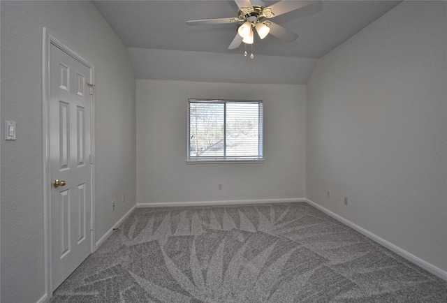 spare room featuring lofted ceiling, carpet flooring, a ceiling fan, and baseboards