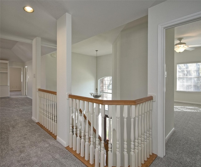 corridor featuring an upstairs landing, carpet, baseboards, and a healthy amount of sunlight