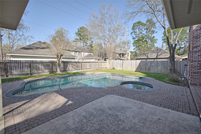 view of swimming pool with a patio, a fenced backyard, and a pool with connected hot tub