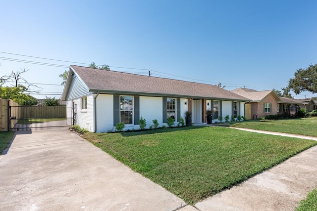 ranch-style house featuring brick siding, a front lawn, fence, concrete driveway, and roof with shingles