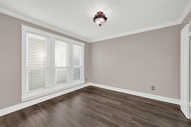 empty room featuring dark wood-type flooring, baseboards, and ornamental molding