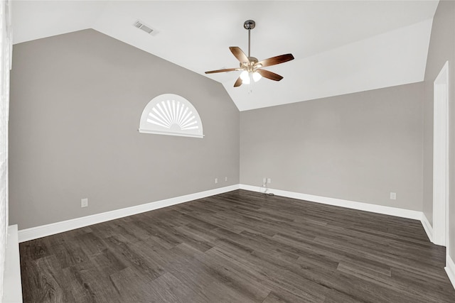 spare room with visible vents, baseboards, lofted ceiling, a ceiling fan, and dark wood-style flooring