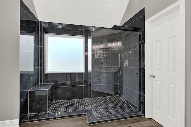 full bathroom featuring a stall shower and wood finished floors