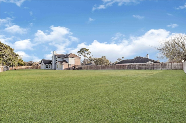 view of yard with a fenced backyard