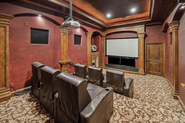 carpeted cinema room featuring crown molding, baseboards, a tray ceiling, decorative columns, and recessed lighting